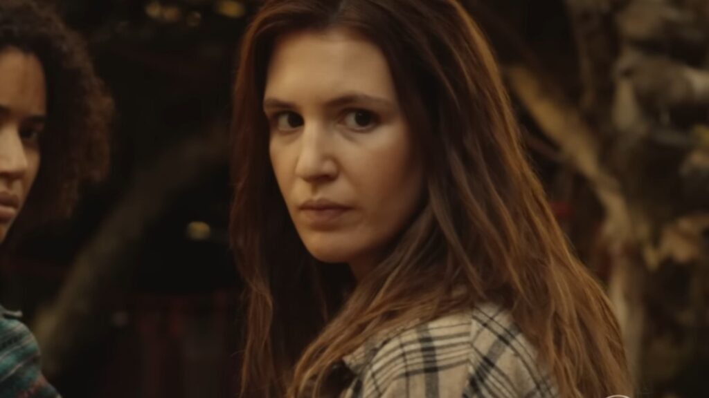 Lauren Ambrose as adult Van Palmer watching surroundings in Yellowjackets Season 3