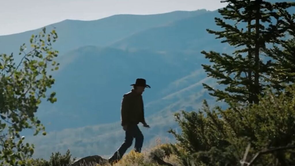Luke Grimes as Kayce Dutton walking Montana ridgeline in Marshals series, from Marshals