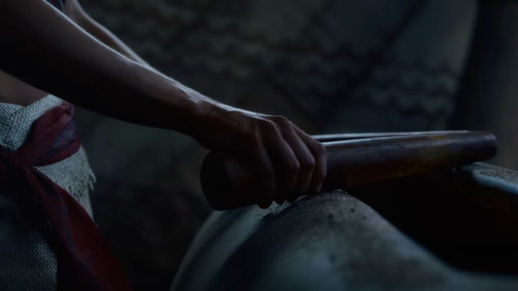 Close-up of a hand gripping a ceremonial paddle in Moana Live Action.