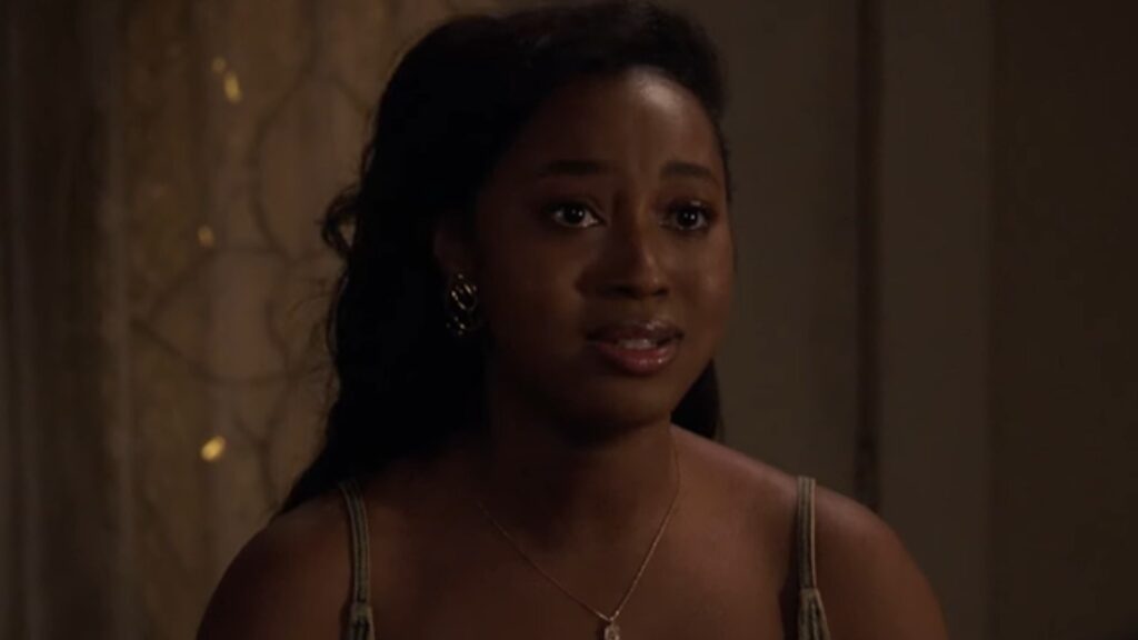 Chelsea Tavares as Patience Robinson speaking softly in dim room concerned