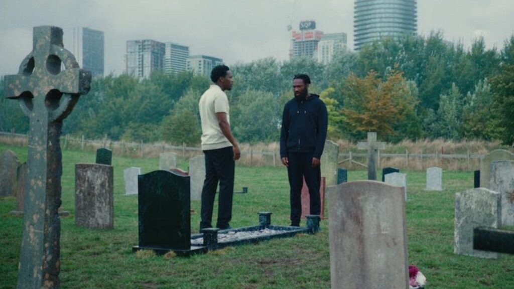 Tosin Cole and Josh Tedeku standing in cemetery emotional scene, from Supacell season 1