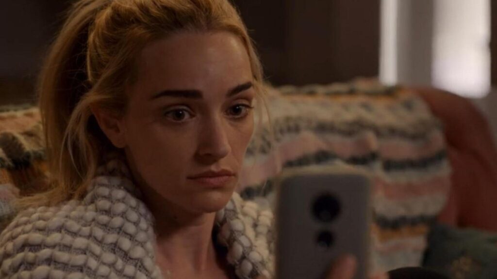 Antonia Gentry as Ginny looking concerned at phone emotional moment, from Ginny & Georgia