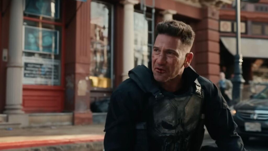 Jon Bernthal as Punisher injured standing on New York street intense scene, from Spider-Man Brand New Day