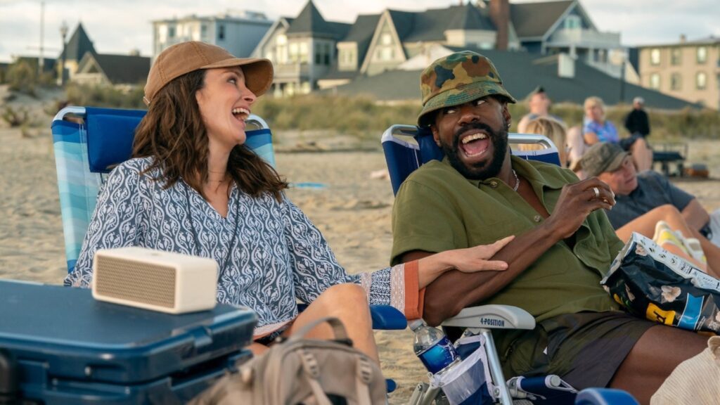 Tina Fey and Colman Domingo laughing together on beach chairs in The Four Seasons season 2