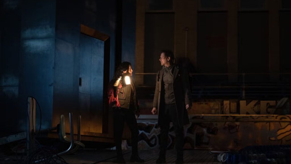 Jennifer Connelly and Joel Edgerton explore dark rooftop with lantern light, from Dark Matter season 2