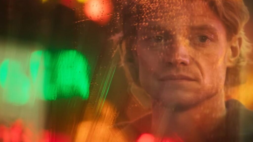 Tom Rhys Harries as Matt Hagen seen through rain soaked window, from Clayface 2026