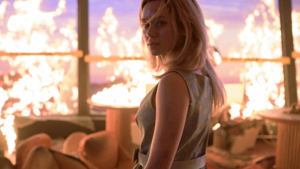 Young woman stares back while fire engulfs room in Final Destination: Bloodlines