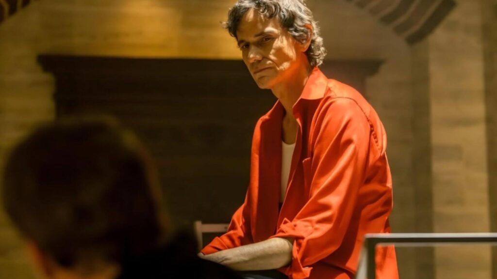 Christian Camargo as Brian Moser in red shirt confronting someone in Dexter: Resurrection