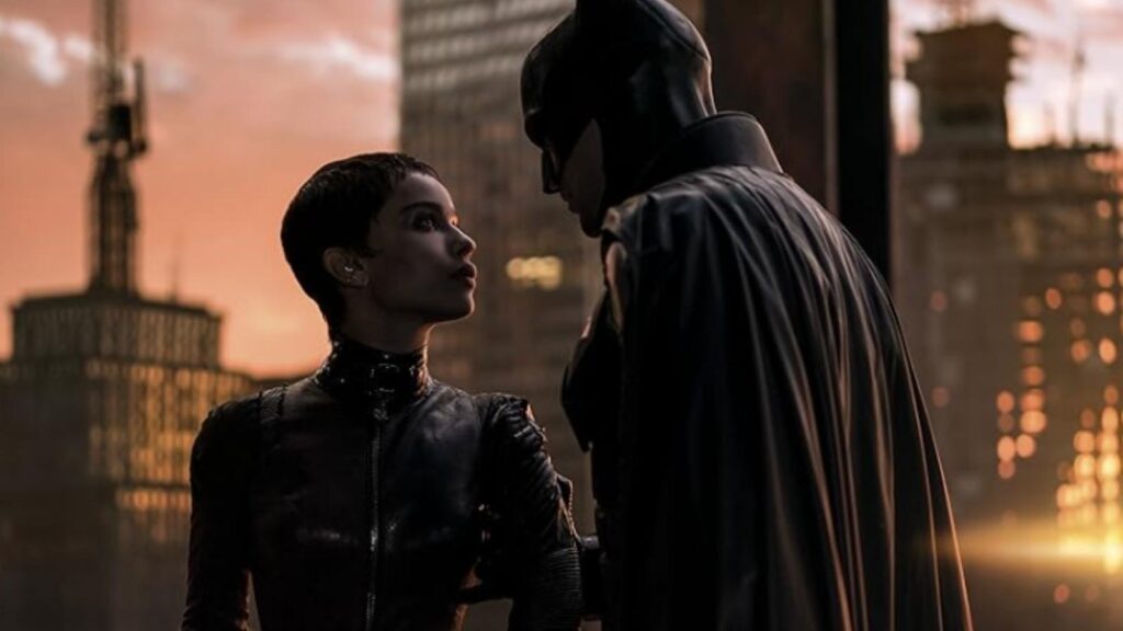 Zo&euml; Kravitz and Robert Pattinson in The Batman overlooking Gotham skyline at sunset