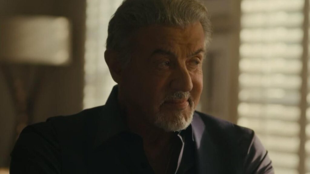 Sylvester Stallone looks across the room during a quiet Tulsa King conversation Tulsa King season 3