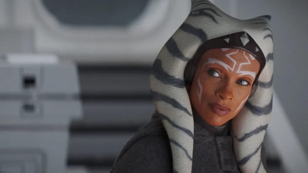 Rosario Dawson as Ahsoka Tano watching from a starship corridor, from Ahsoka