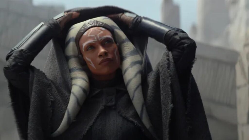 Rosario Dawson as Ahsoka Tano raising her cloak outside, from Ahsoka