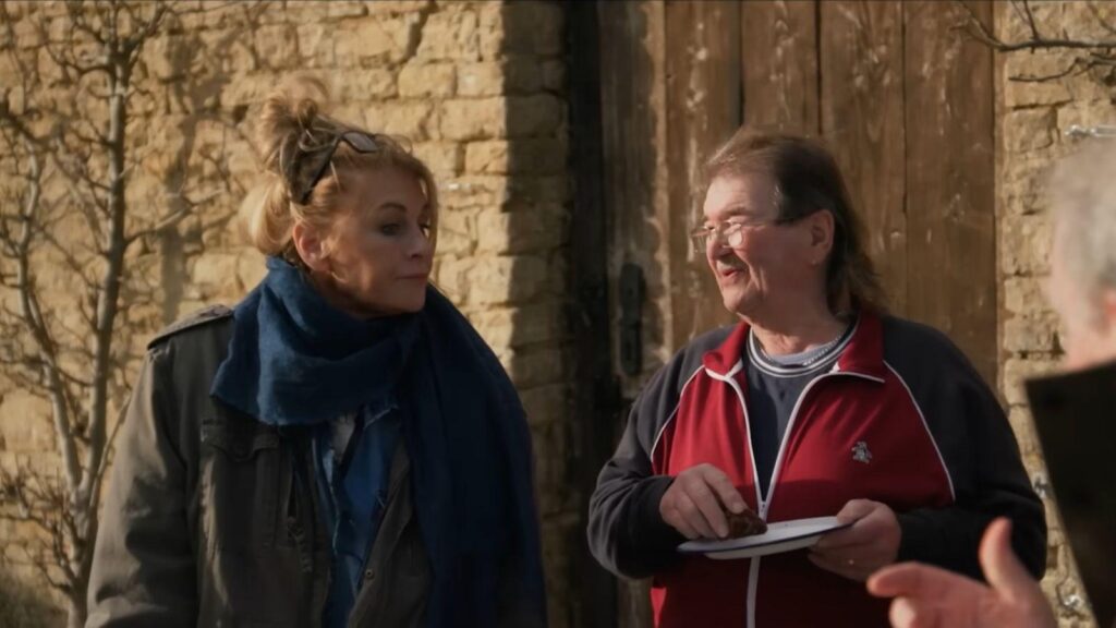 Lisa Hogan and Gerald Cooper chat outside stone barn in countryside, from Clarkson's Farm season 5