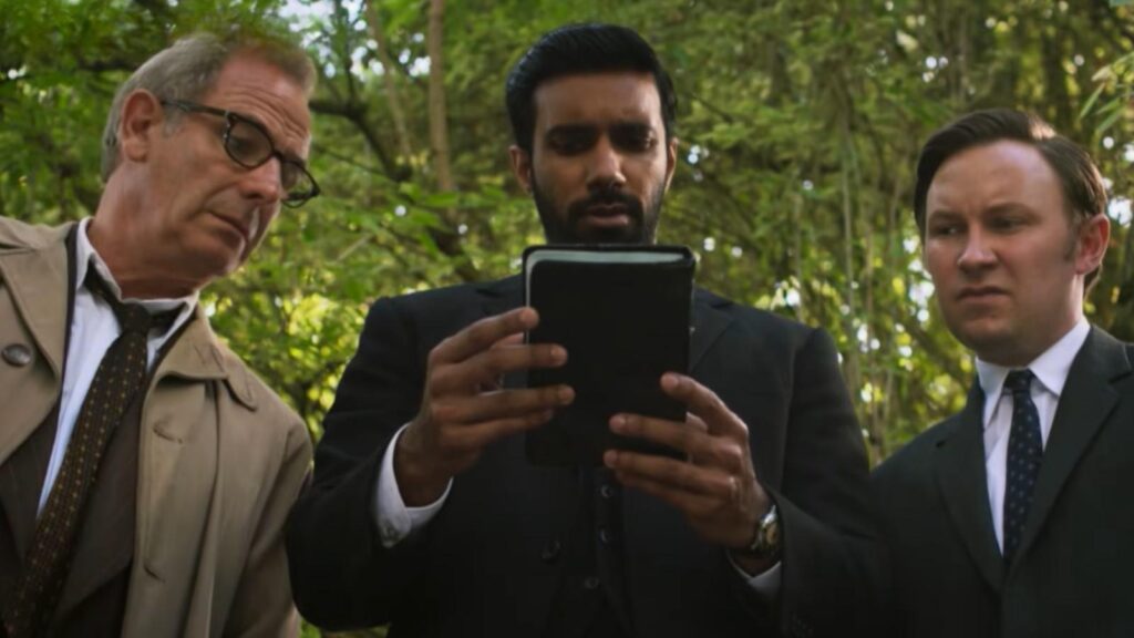 Robson Green, Rishi Nair, and Bradley Hall checking a tablet, from Grantchester Season 11 trailer