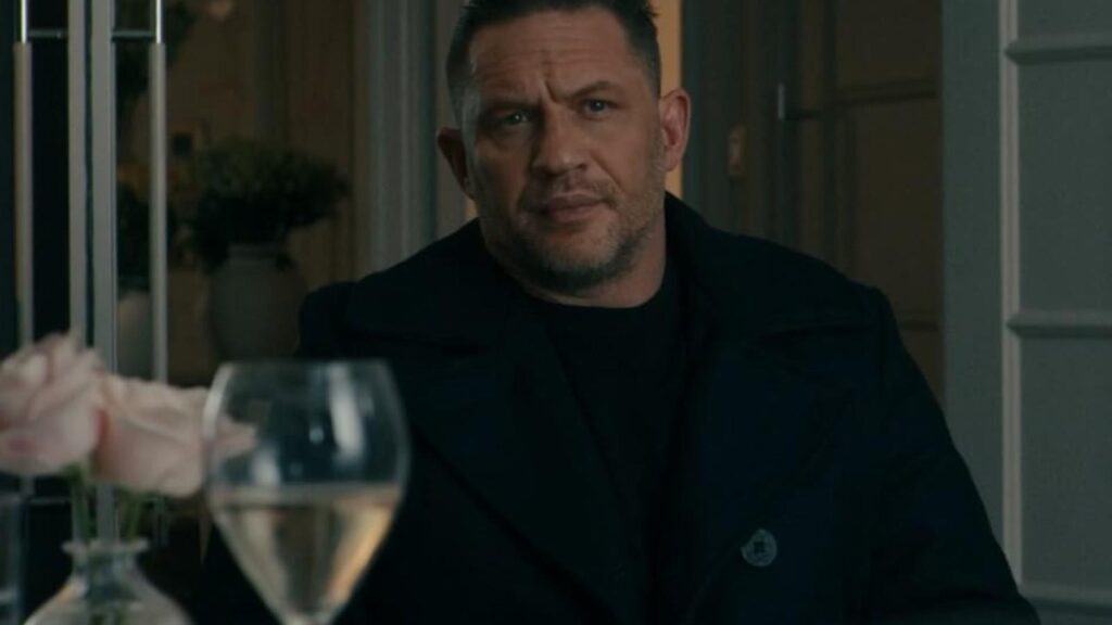 Tom Hardy as Harry Da Souza sits in tense doorway scene, from MobLand