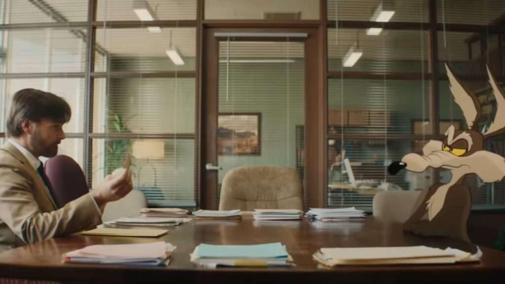 Will Forte as Kevin Avery sits with Wile E Coyote office, from Coyote vs Acme