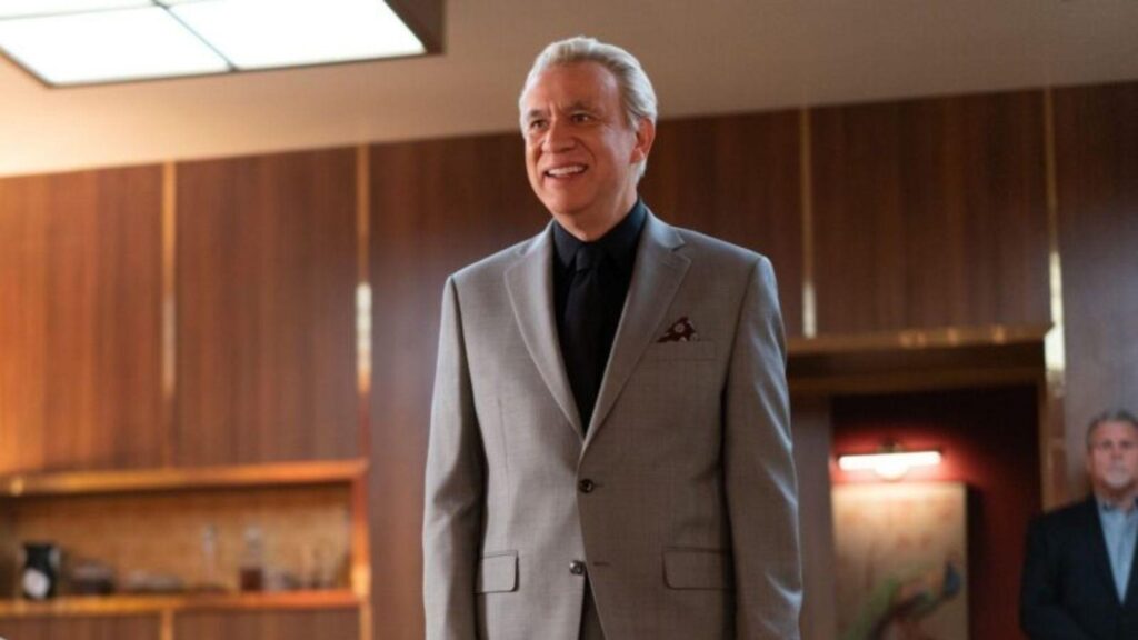 Fred Armisen as Max Sugar stands confidently in sleek office setting, from Deli Boys season 2