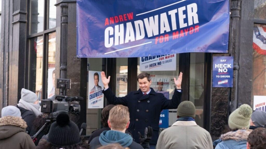 Andrew Rannells as Andrew Chadwater campaigns for mayor in public rally scene, from Deli Boys season 2
