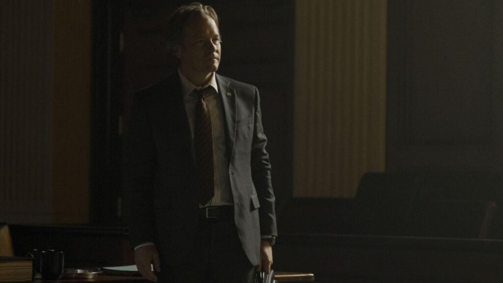 Peter Sarsgaard as Tommy Molto in courtroom during tense legal proceedings, from Presumed Innocent Season 1