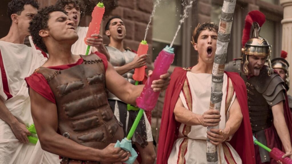 Rish Shah, Benito Skinner, and Adam DiMarco in water fight scene, from Overcompensating Season 2