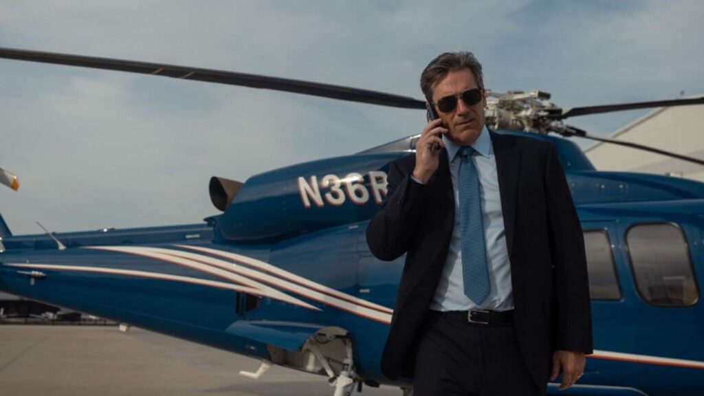 Billy Bob Thornton talks on phone beside helicopter runway,  from Landman season 2