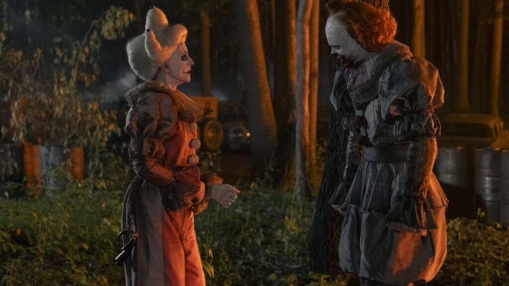 Bill Skarsgård as Pennywise meets another clown in eerie forest scene From: IT: Welcome to Derry season 1