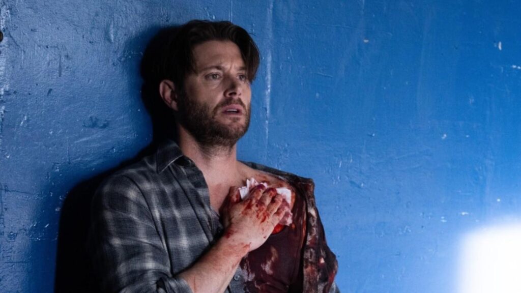 Jensen Ackles appears injured while leaning against a wall in Tracker Season 3