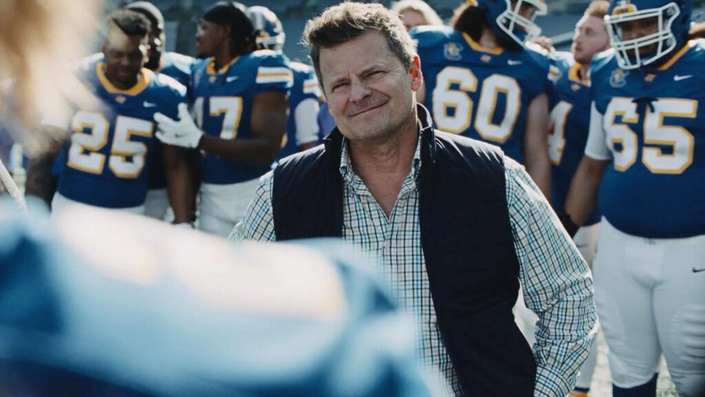 Coach Jake Hudson addresses Catfish players before practice on the field, from Chad Powers season 2